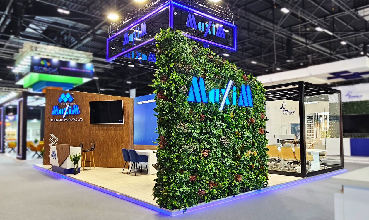Exhibition stand with green wall and illuminated logo